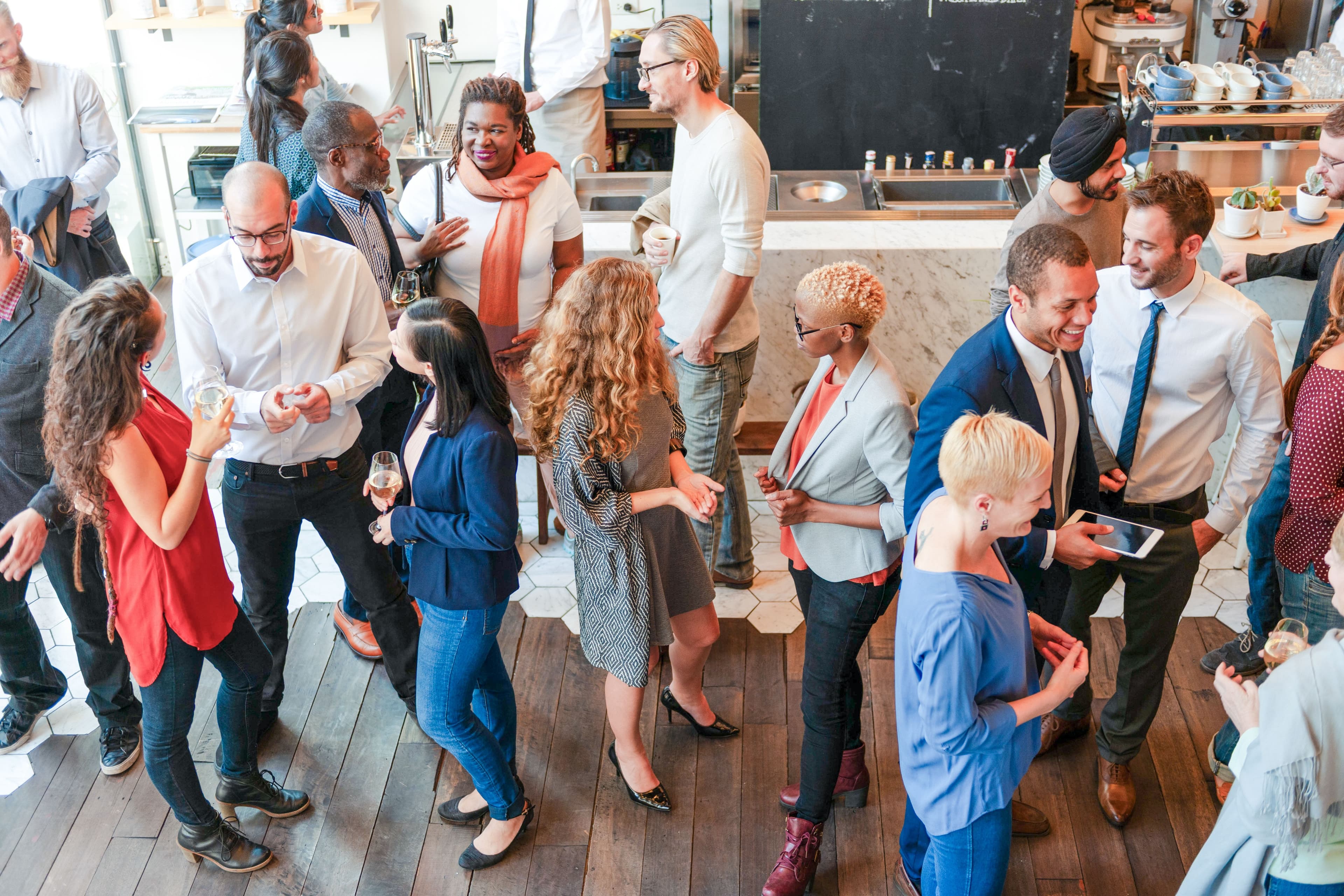 people mingling and chatting at an indoor networking event AdobeStock 1974619447