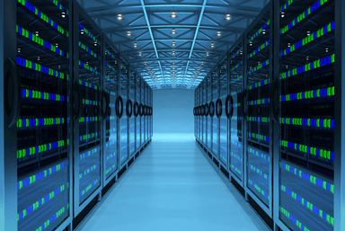 Rows of illuminated server racks in a data centre corridor