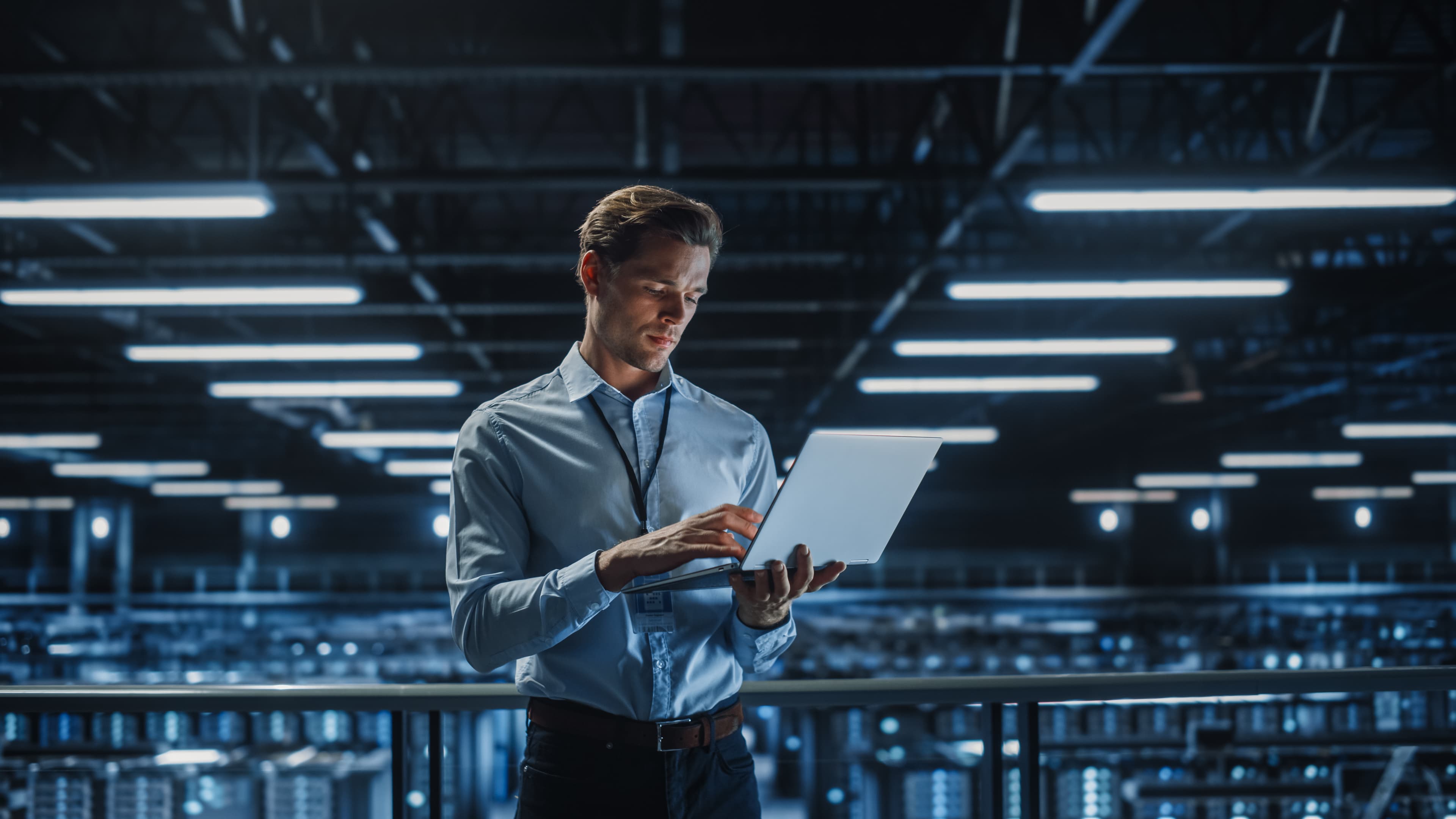 Professional using a laptop within an advanced technology facility