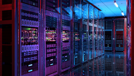 Rows of illuminated data centre server racks representing digital infrastructure for homelessness prevention