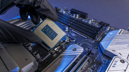 Computer processor in a gloved hand against the background of the motherboard iStock-1769166746.jpg 2