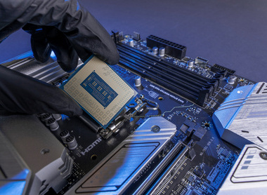 Computer processor in a gloved hand against the background of the motherboard iStock-1769166746.jpg 2