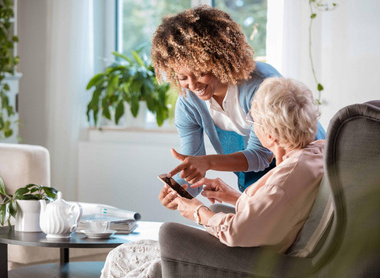 Friendly nurse supporting senior woman.jpg